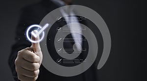 Businessman touching digital checklist icon representing document approval process quality control task management and successful