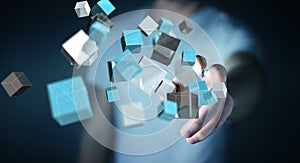 Businessman touching floating blue shiny cube network 3D rendering