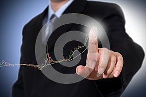 Businessman Touching a Graph Indicating Growth