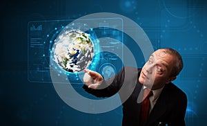 Businessman touching high-tech 3d earth panel