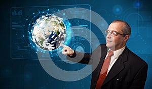 Businessman touching high-tech 3d earth panel