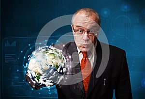 Businessman touching high-tech 3d earth panel