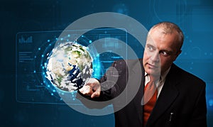 Businessman touching high-tech 3d earth panel