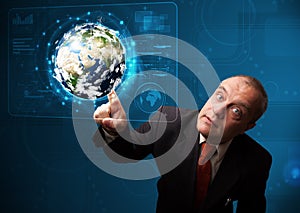 Businessman touching high-tech 3d earth panel