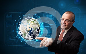 Businessman touching high-tech 3d earth panel