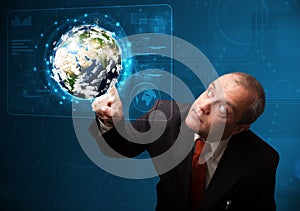 Businessman touching high-tech 3d earth panel
