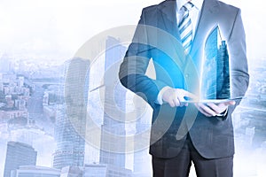 Businessman touching tablet with 3d city model