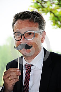 businessman with toy moustache and glasses