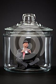 Businessman trapped inside a jar