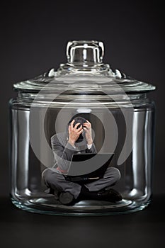 Businessman trapped inside a jar
