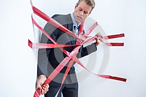 Businessman trapped by red tape