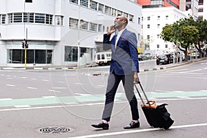 Businessman traveling and talking on cell phone