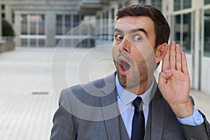 Businessman trying to hear a gossip