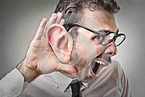 Businessman trying to listen to