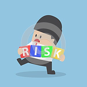 Businessman trying to manage risk block