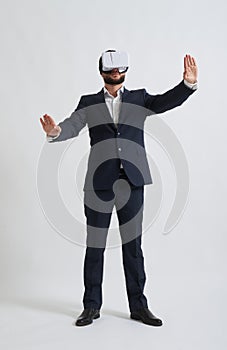 Businessman trying to push something wearing virtual reality glasses