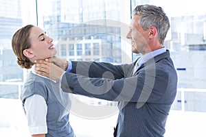 Businessman trying to smother his colleague