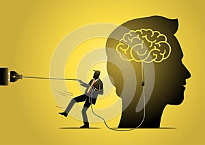 A businessman trying to unplug the brain Business concept