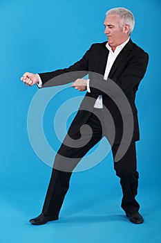 Businessman tugging invisible rope photo