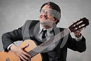 Businessman tuning the guitar