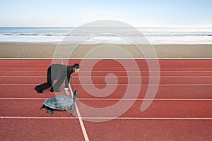 Businessman and turtle are ready to race on running track