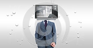 Businessman with TV on face standing against abstract background