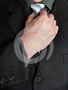 Businessman tweaking his tie