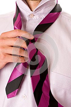 Businessman tying his necktie