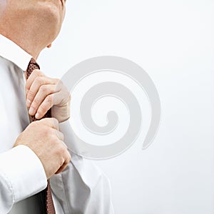 Businessman tying necktie