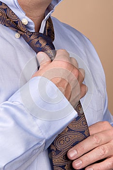 Businessman tying necktie