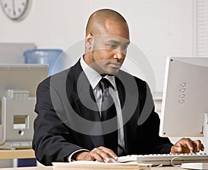 Businessman typing on computer at desk