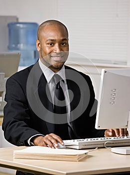 Businessman typing on computer at desk