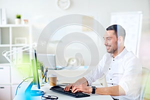 Businessman typing on computer keyboard at office