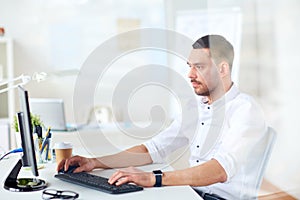 Businessman typing on computer keyboard at office