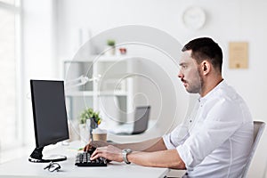 Businessman typing on computer keyboard at office