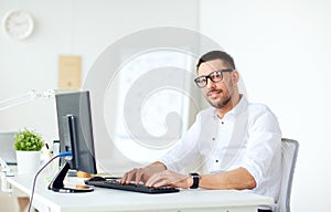 Businessman typing on computer keyboard at office photo