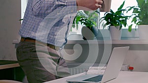 Businessman typing in data on a laptop