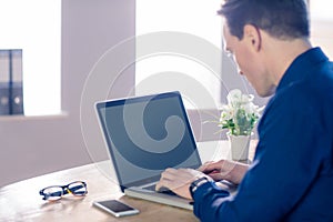 Businessman typing on his laptop