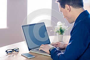 Businessman typing on his laptop