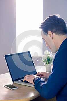 Businessman typing on his laptop