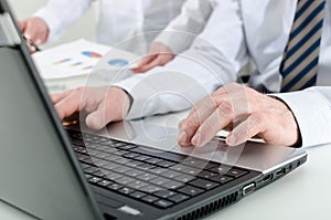 Businessman typing on his laptop