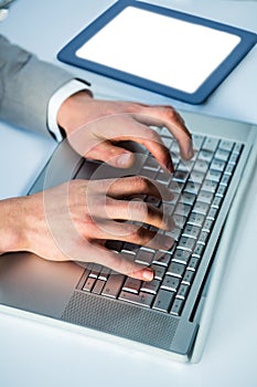 Businessman typing on his laptop