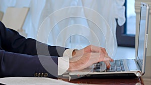 Businessman is typing on laptop computer