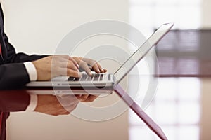 Businessman typing on laptop computer