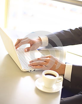 Businessman typing on laptop computer