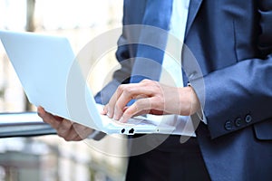 Businessman typing on laptop computer