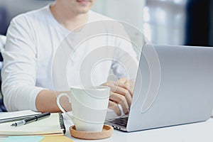 Businessman typing on laptop  in home office hand keyboard