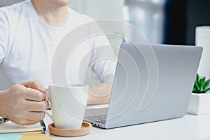 Businessman typing on laptop  in home office hand keyboard