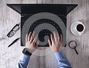 Businessman typing on a laptop keyboard. Business concept