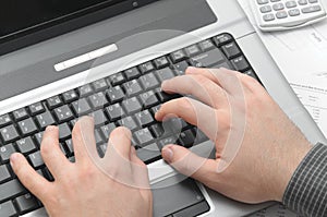 Businessman typing on notebook (laptop)